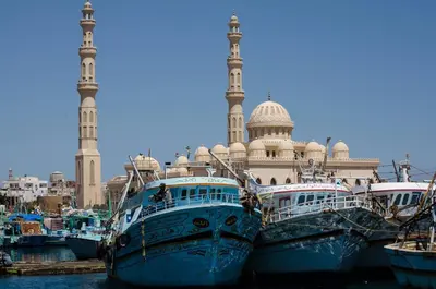 a group of boats parked in the water in front of a mosque at Diamond Arabia Orange in Hurghada