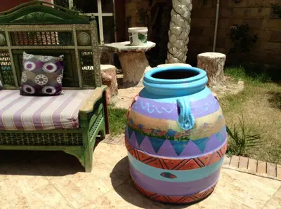 a large colorful vase sitting next to a chair at Diamond Arabia Orange in Hurghada