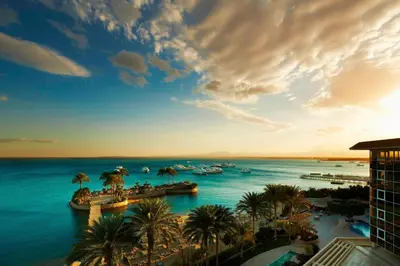 a view of a body of water with palm trees and boats at Hurghada Marriott Beach Resort in Hurghada