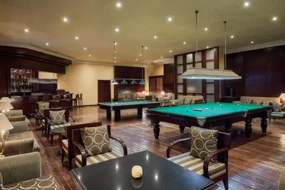 a billiard room with two pool tables and chairs at JAZ Grand Marsa in Coraya Bay