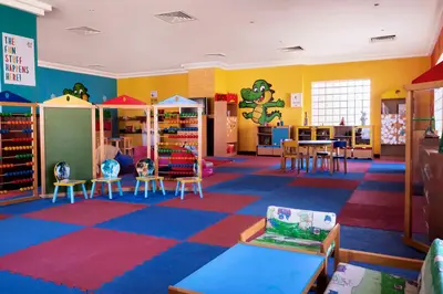 a classroom with a colorful room with chairs and tables at JAZ Grand Marsa in Coraya Bay