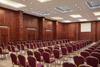 an empty lecture hall with chairs and a screen at JAZ Grand Marsa in Coraya Bay