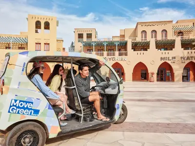 a group of people riding in a golf cart at Hotel Sultan Bey Resort in Hurghada
