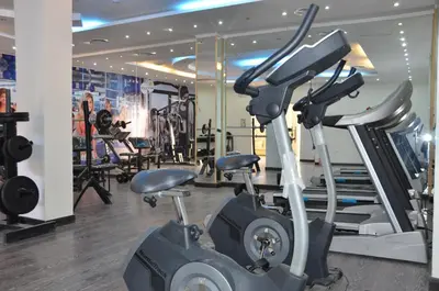 a gym with two exercise bikes and tread machines at Three Corners Sunny Beach Resort in Hurghada