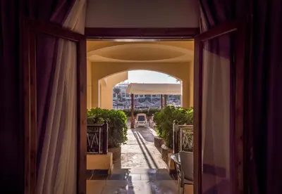 an open door to a balcony with an archway at Sunny Days Palma De Mirette Resort & Spa in Hurghada