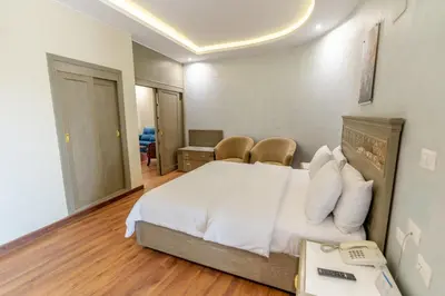a bedroom with a bed and a phone in it at Lotus Luxor Hotel in Luxor