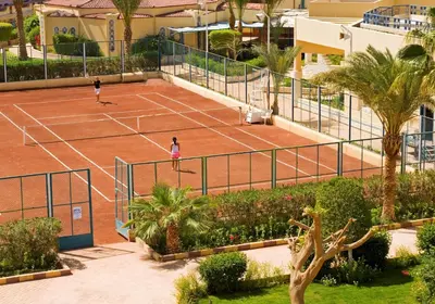 two people playing tennis on a tennis court at Sunny Days Mirette Family Resort in Hurghada