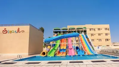 a water slide in front of a swimming pool at Sunny Days Mirette Family Resort in Hurghada