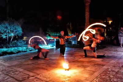 a group of people performing a fire show at night at JAZ Makadina in Hurghada