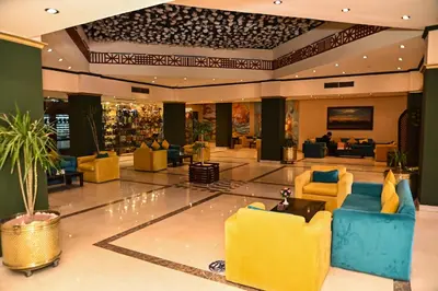 a lobby with yellow and blue chairs in a hotel at Eagles Paradise Abu Soma Resort in Hurghada