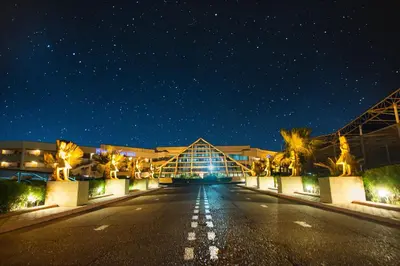 an empty street in front of a building at night at Pharaoh Azur Resort in Hurghada