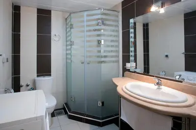 a bathroom with a sink and a glass shower at Royal Beach Serviced Apartments in Hurghada