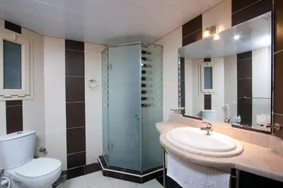 a bathroom with a toilet and a sink and a shower at Royal Beach Serviced Apartments in Hurghada