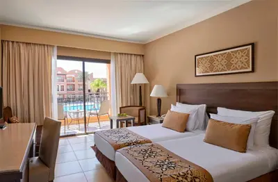 a hotel room with a bed and a balcony at JAZ Neo Dar El Madina in Coraya Bay