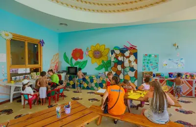 a group of children sitting at tables in a classroom at Titanic Beach - Families and Couples only in Hurghada
