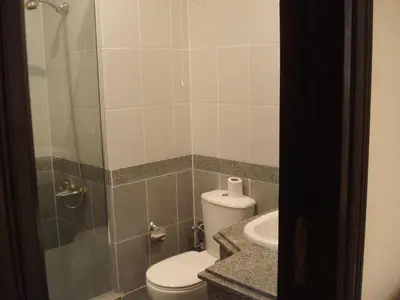 a bathroom with a toilet and a sink and a shower at Palm Beach Apartments 302B in Hurghada