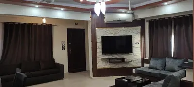 a living room with a couch and a tv on a wall at Hurghada Big private villa for families in Hurghada