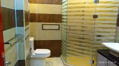 a bathroom with a toilet and a glass shower at Hurghada Big private villa for families in Hurghada