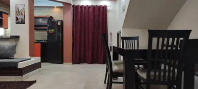 a living room with a table and a red curtain at Hurghada Big private villa for families in Hurghada