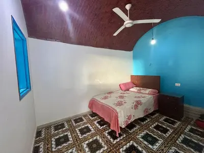 a bedroom with a bed and a ceiling fan at Al Salam Camp in Luxor