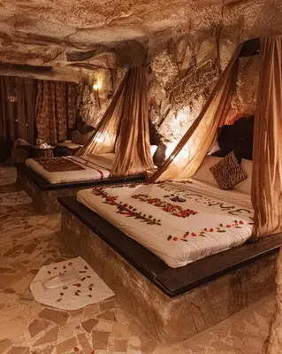 two beds in a room in a cave at Caves Beach Resort Adults Only in Hurghada