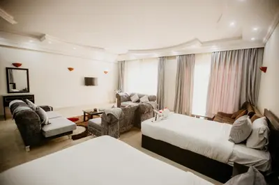 a living room with two beds and a couch at Caves Beach Resort Adults Only in Hurghada
