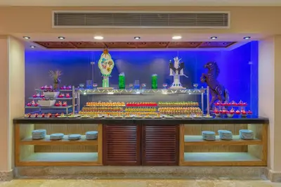 a store with a display of food and plates at Gravity Hotel & Aqua Park Hurghada Families and Couples Only in Hurghada