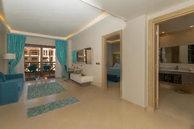 a living room with a blue couch and a living room with at Gravity Hotel & Aqua Park Hurghada Families and Couples Only in Hurghada
