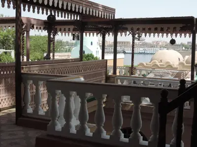 a balcony with a view of a mosque at Villa Nile House Luxor in Luxor