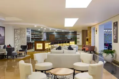 a lobby with a couch and chairs and a bar at Marina Resort Port Ghalib, a member of Radisson Individuals in Port Ghalib