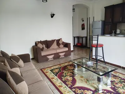 a living room with a couch and a glass table at Luxor Star Apartments in Luxor
