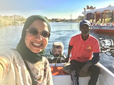 a woman and a man on a boat on the water at Nuba Narty in Aswan