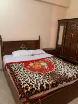 a bed in a bedroom with a blanket on it at Villa Elhag Nile View in Luxor