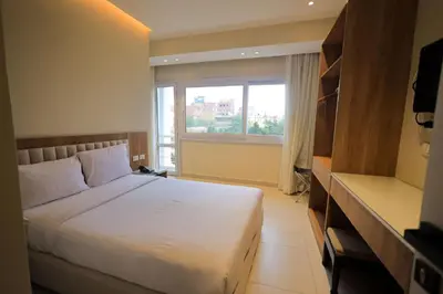 a bedroom with a large bed and a window at Hapi Hotel in Aswan