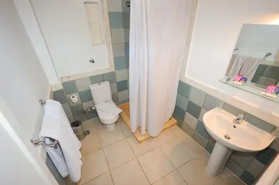 a bathroom with a sink and a toilet and a shower at Hapi Hotel in Aswan
