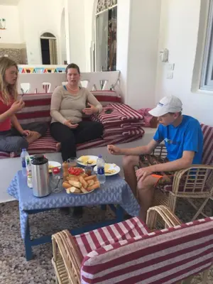 a group of people sitting in a living room at The Mango Guest House in Aswan