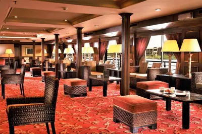 a hotel lobby with chairs and tables and tablesktop at JAZ Crown Jubilee Nile Cruise - Every Thursday from Luxor for 07 & 04 Nights - Every MondayFrom Aswan for 03 Nights in Luxor