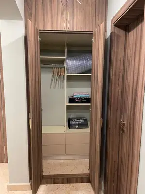 a closet with a wooden cabinet with a mattress at El Gouna South Marina 1 Bedroom Apartement with private Jacuzzi in Hurghada