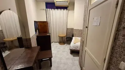 a room with a desk and a room with a bed at Canary Hotel in Hurghada