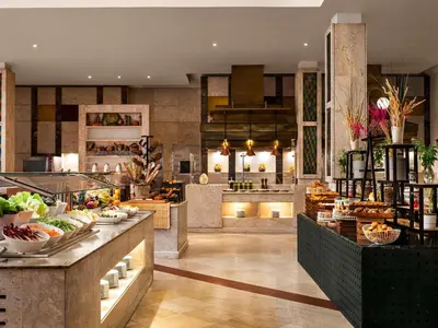 a restaurant with a bunch of food on display at Movenpick Resort & Spa El Gouna in Hurghada