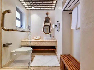 a bathroom with a glass shower and a sink at Movenpick Resort El Quseir in Quseir