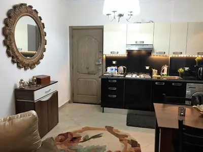 a kitchen with a table and a mirror on the wall at Pool View Apartments at British Resort - Unit 13 in Hurghada