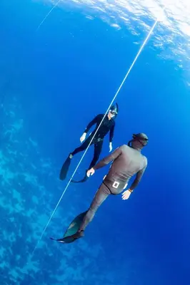 two people in the water holding onto a rope at Robinson Soma Bay in Hurghada