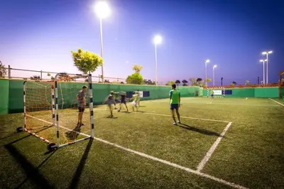a group of people playing tennis on a tennis court at Robinson Soma Bay in Hurghada