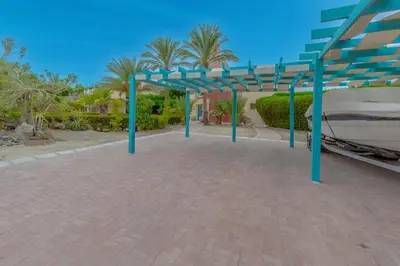 a bed with a blue canopy on a brick patio at Stunning Villa for Rent in El Gouna HEATED PRIVATE POOL in Hurghada