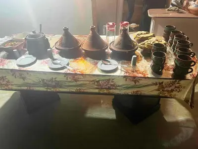 a table with a bunch of pots on it at Gold Ibis Hotel in Luxor