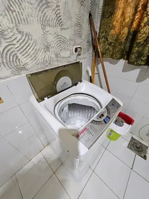 a white toilet in a bathroom with its seat up at chalet Stella de Mari in Makadi Bey in Hurghada