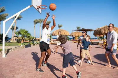 a group of people playing a game of basketball at Three Corners Sea Beach Resort in Coraya Bay