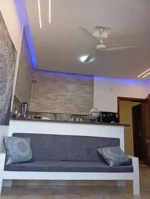 a couch in a living room with a ceiling fan at Villamar Sea View rooms & apartments in Hurghada