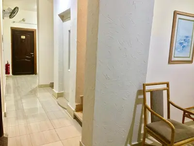 a hallway with a chair and a door at Masaya Hurghada in Hurghada